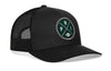 Black trucker hat with green round logo patch and black mesh back, snapback closure
