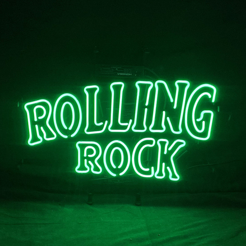 Green neon sign reading “ROLLING ROCK” with large text on dark background