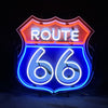 Neon Route 66 sign featuring orange top border, blue numbers 66, and ROUTE lettering.
