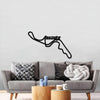 Black Suzuka circuit wall art above a gray sofa