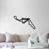 Black Suzuka circuit metal wall art above a white sofa
