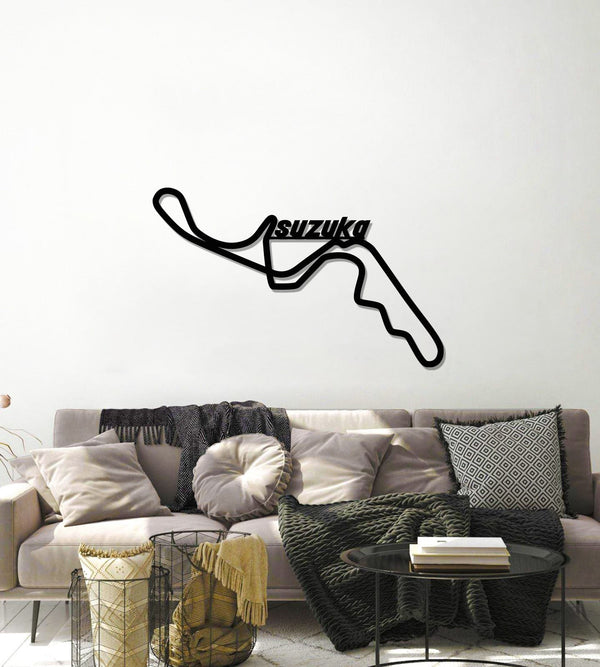 Black Suzuka circuit wall art above a gray living room sofa