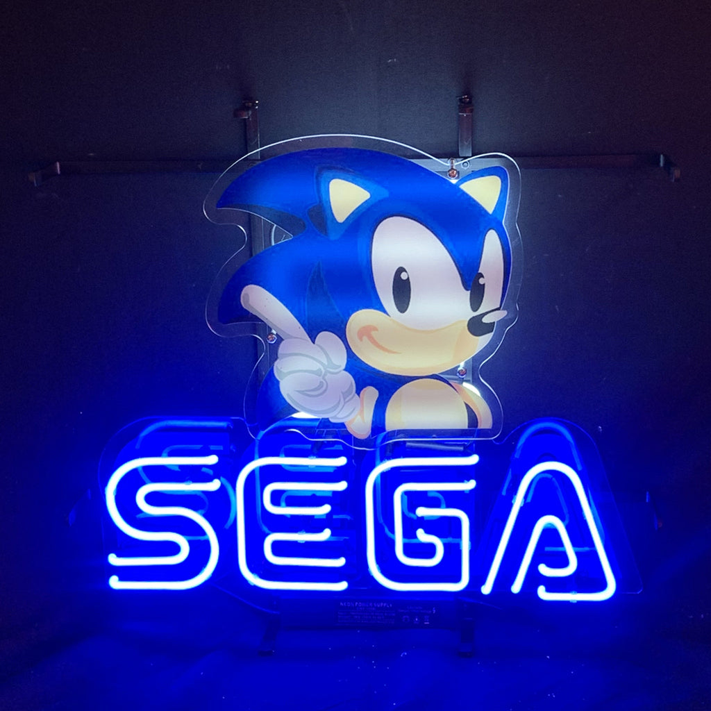 Blue character neon sign with outline 'SEGA' light lettering