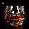 Faceted crystal whisky glass with amber pour, close-up view