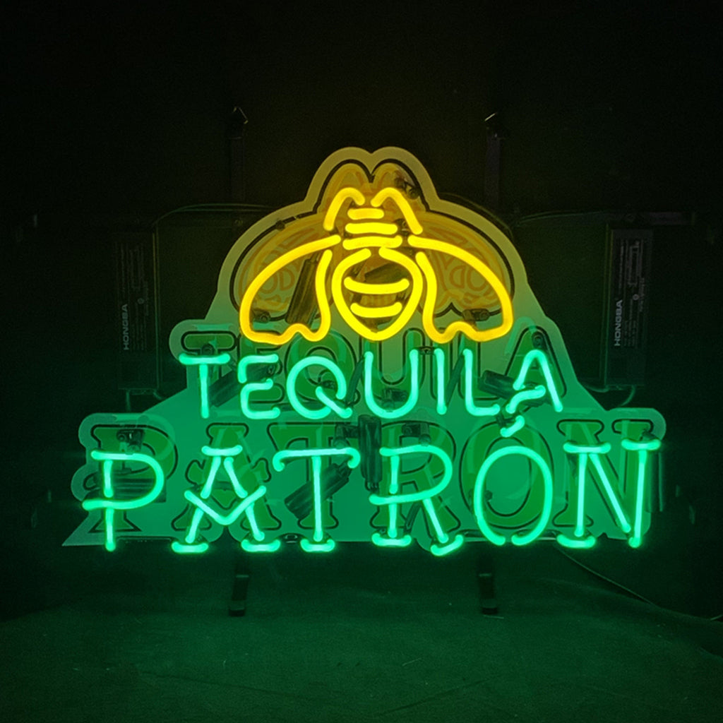 Front view neon acrylic sign 'TEQUILA PATRON' with Patron face logo, yellow and green.
