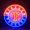 Circular neon light sign featuring a glowing T over a baseball with multicolor text