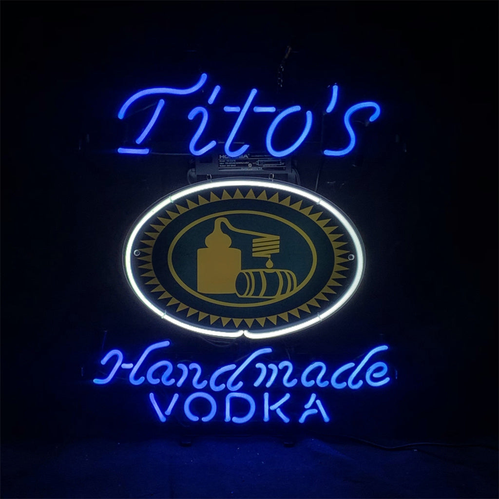 Blue neon sign with centered oval emblem and 'Tito's' and 'Vodka' lettering