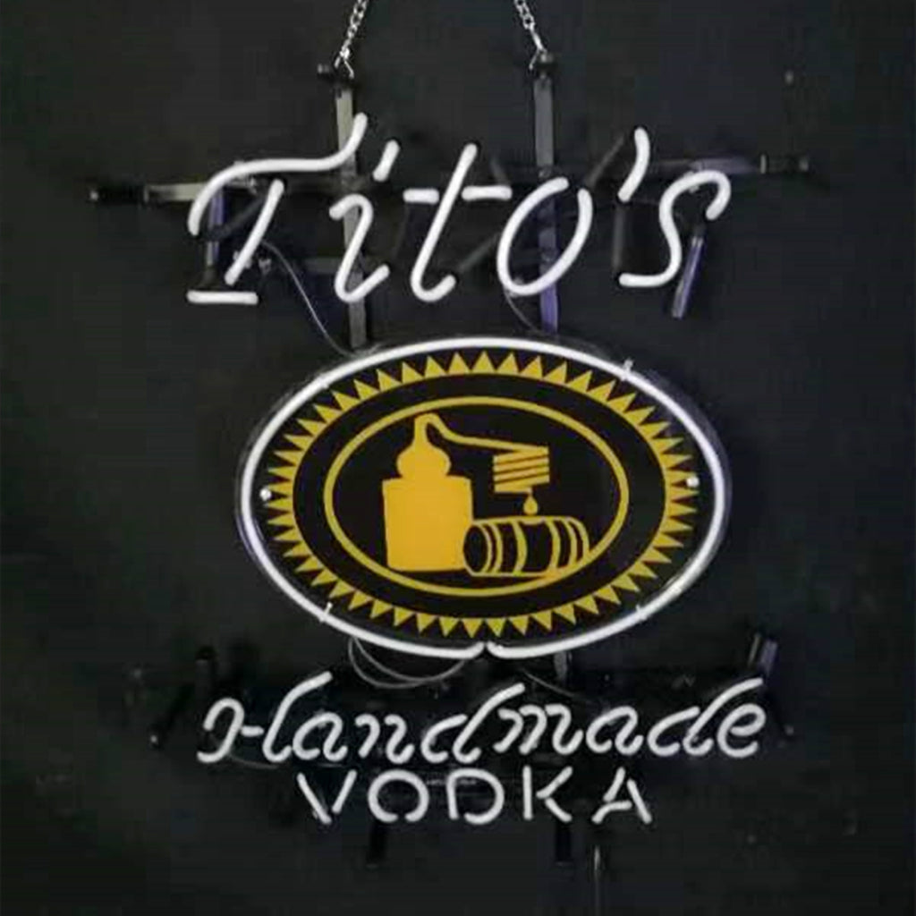 Hanging blue neon sign with chains, oval emblem, and glowing 'Tito's' and 'Vodka'