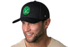 Black trucker cap with green crossed clubs patch worn by man, snapback brim.