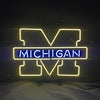University of Michigan neon logo sign, yellow UM outline, blue MICHIGAN text, with cord