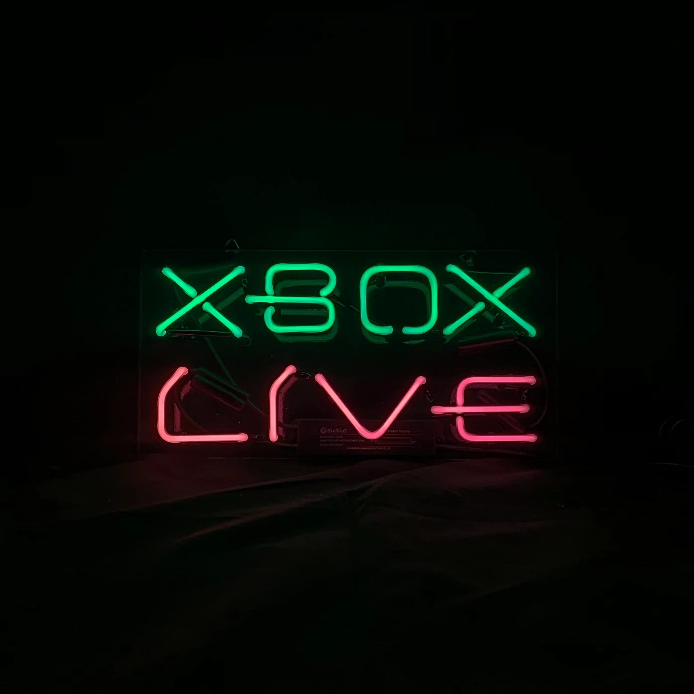 Rectangular neon sign with green XBOX and red LIVE lettering, centered