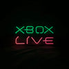 Rectangular neon sign with green XBOX and red LIVE lettering, centered