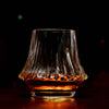 Fluted crystal whisky glass holding amber whisky
