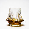 Japanese crystal whisky glass with amber liquid and fluted texture around the sides