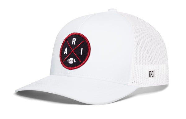 White trucker hat with red round logo patch, white mesh sides, and snapback strap.