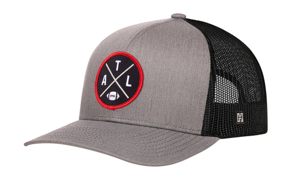 Gray trucker cap with black mesh side panels and red AXL logo patch on front.