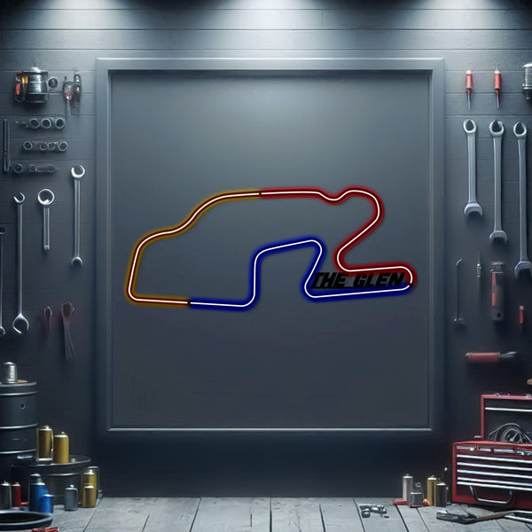 Neon metal race track sign with red, blue outline and “THE GLEN” logo