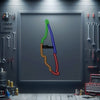 Metal neon race track sign with outlined driver silhouette in multicolor light, framed