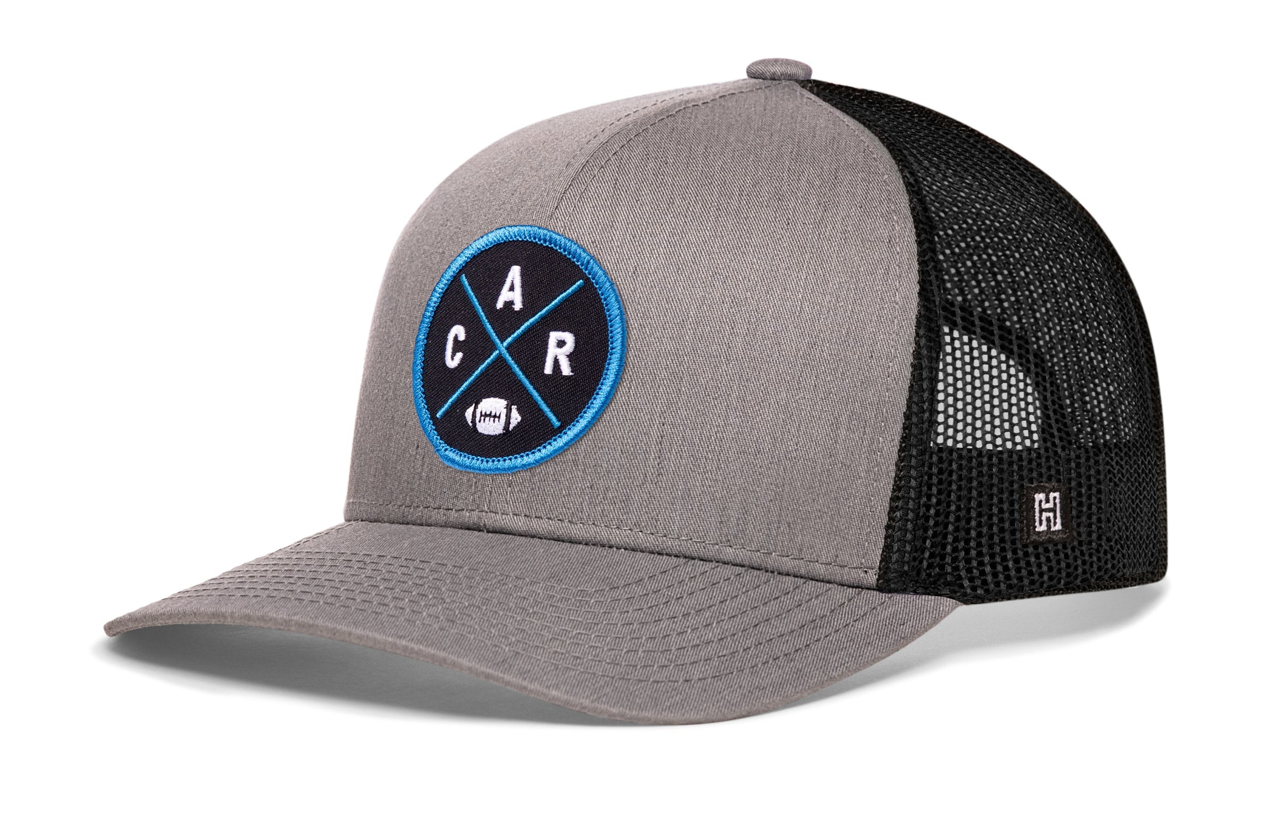 Gray-and-black trucker cap with mesh sides and round CAR X badge on the front, snapback.