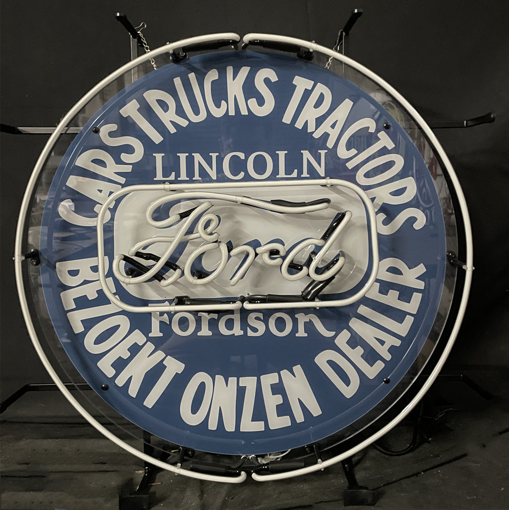 Round blue neon sign with white border ring, “Ford” script and “Lincoln” lettering