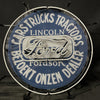 Round blue neon sign with white border ring, “Ford” script and “Lincoln” lettering
