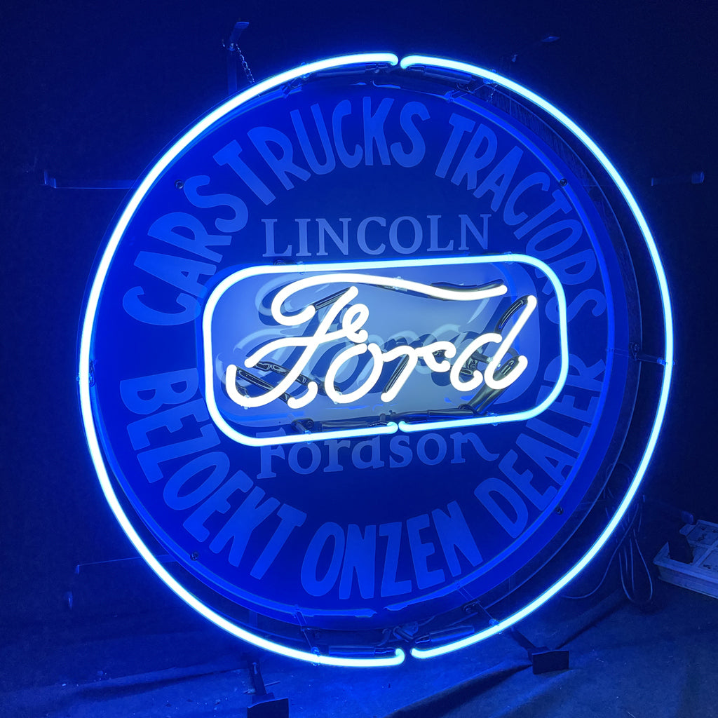 Round blue neon sign showing “Ford” script and “Lincoln” text inside a glowing ring