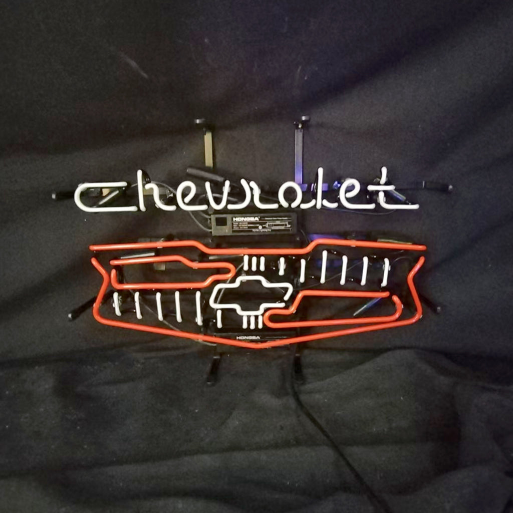 Neon car logo sign with Chevrolet script, grille lights, and two metal hanging brackets