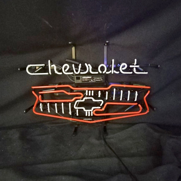 Neon car logo sign with Chevrolet script, grille lights, and two metal hanging brackets