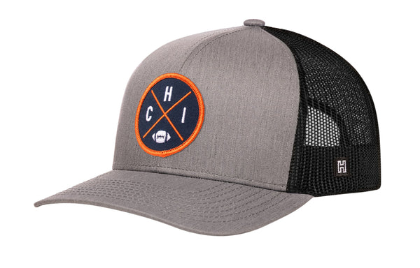 Gray trucker hat with orange logo patch and black mesh back, snapback strap