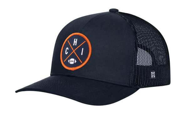 Navy trucker hat with orange logo patch and mesh back, snapback strap