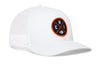 White trucker hat in side profile with orange logo patch and mesh back, snapback