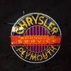 Neon logo sign reading CHRYSLER and PLYMOUTH with 'APPROVED SERVICE' banner