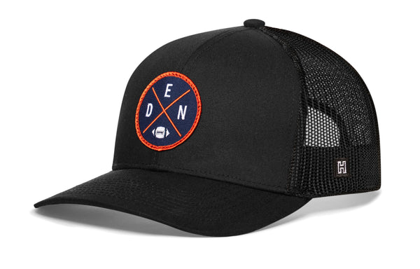 Black trucker hat with round DEN X logo patch and black mesh side panels