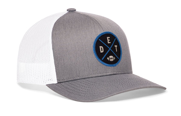 Gray-and-white trucker snapback cap with circular Detroit-style logo patch and side mesh panels