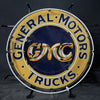 Front view neon circular sign with 'General Motors' and 'Trucks' ring text, GM CMC logo.