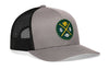 Gray trucker hat with green GB logo patch and black mesh side panels.