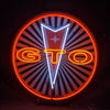 Round neon light sign with orange and yellow GTO letters, star badge, red ring