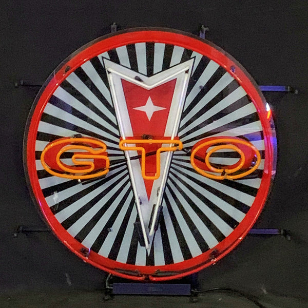 Round GTO neon sign with red rim, white burst rays, orange letters and star