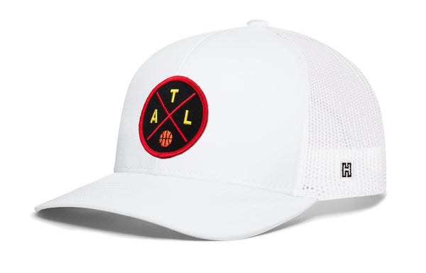 White basketball trucker hat with red circular logo patch, mesh side panels, and H badge.