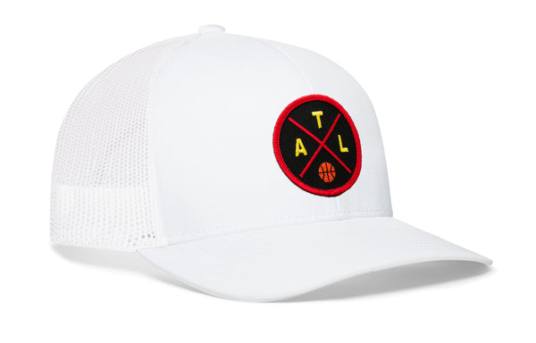 White trucker cap with red circular basketball logo patch and mesh side panels.