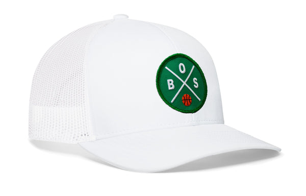 White basketball trucker hat with green B.S. logo patch on the side