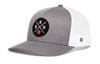Gray trucker cap with circular front logo patch and white mesh side panels, curved brim