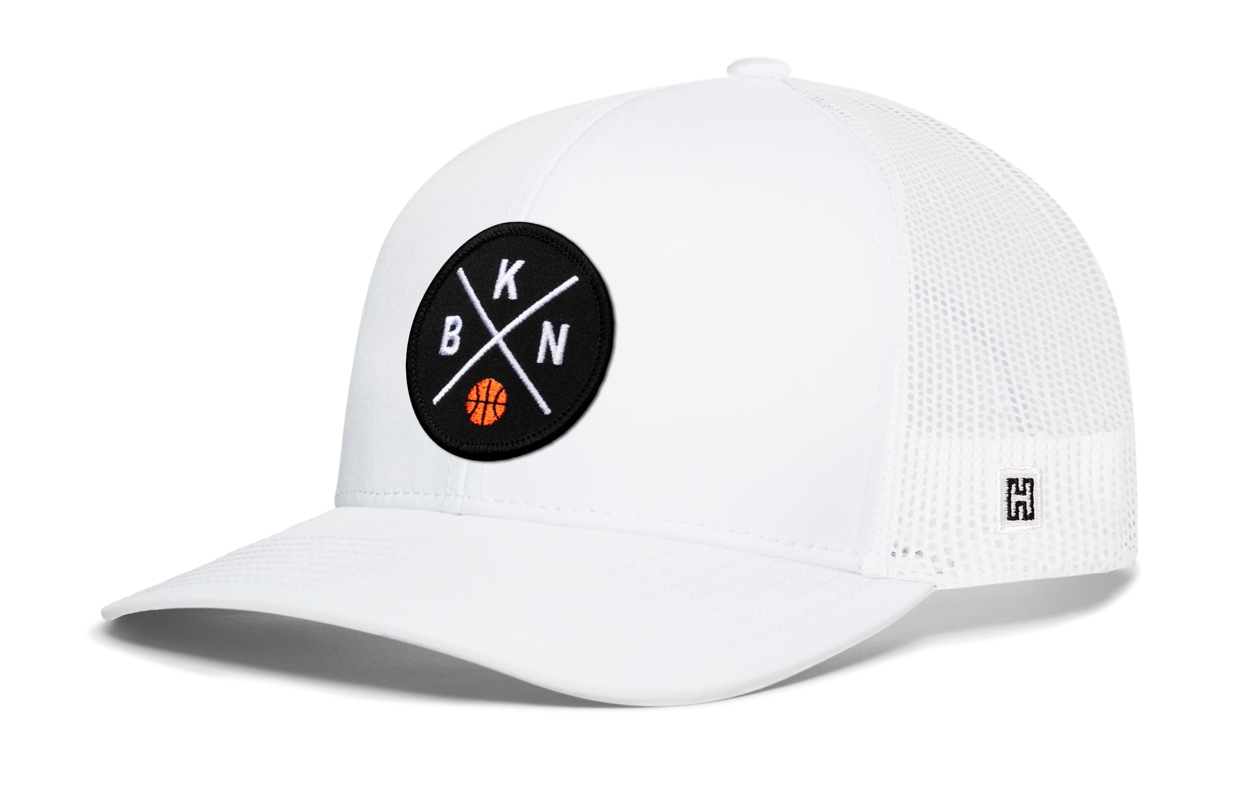 White trucker cap with circular front logo patch and white mesh side panels, curved brim