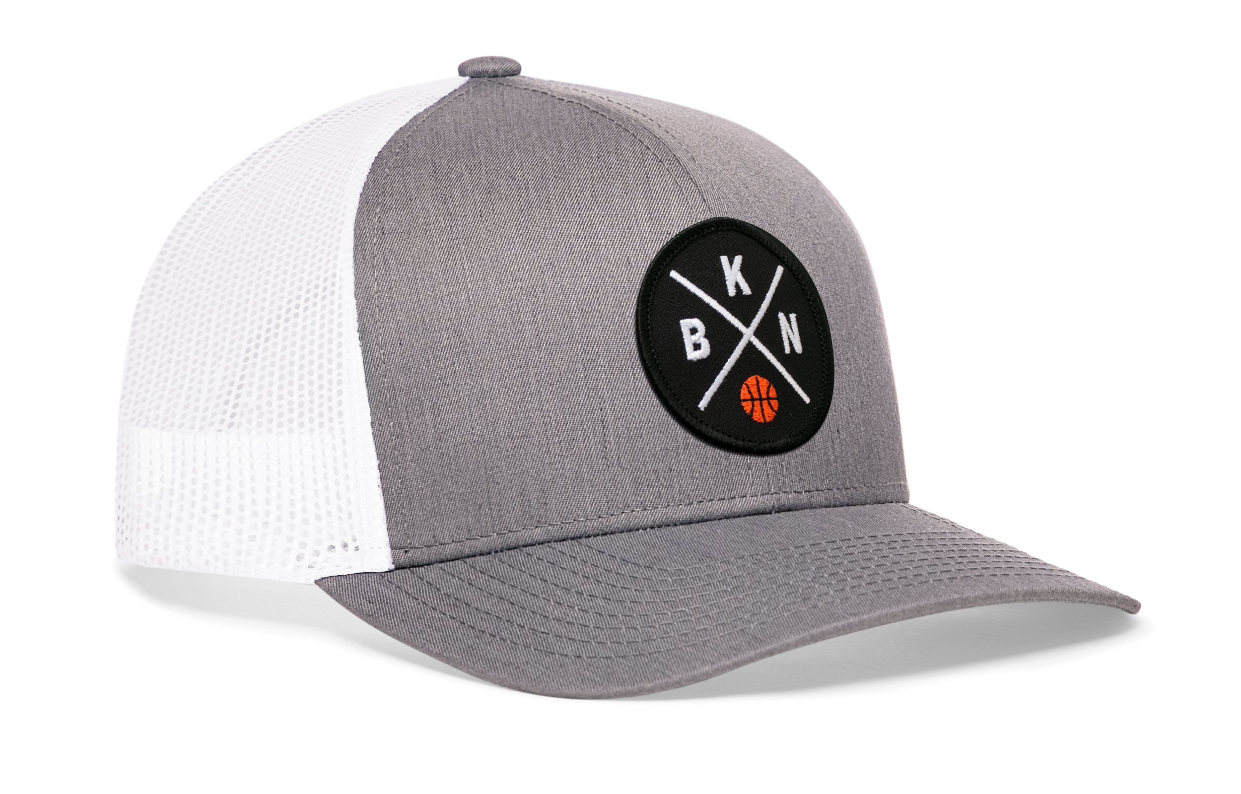 Gray front trucker cap with circular logo patch, white mesh side panels, curved brim