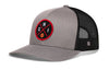Gray trucker snapback cap with black mesh back, curved brim, and red circular logo