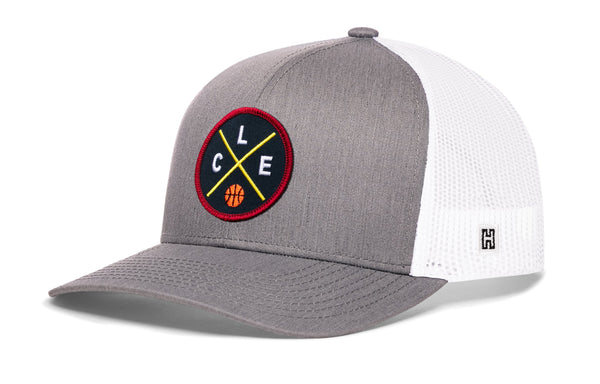 Gray trucker cap with white mesh back, circular logo patch, and small H side
