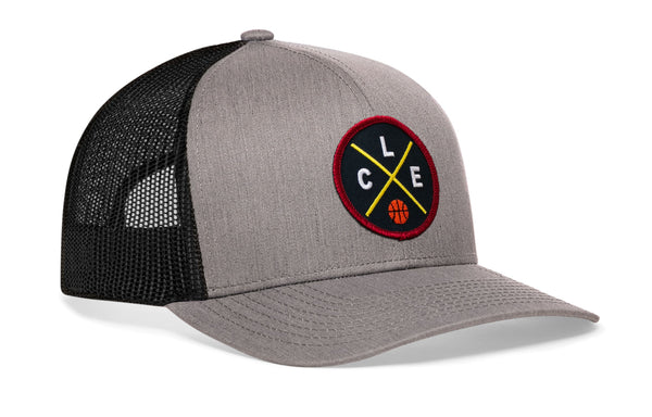 Gray trucker cap with black mesh back and circular logo patch on the front