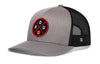 Gray and black trucker snapback hat with front logo patch and mesh side panels
