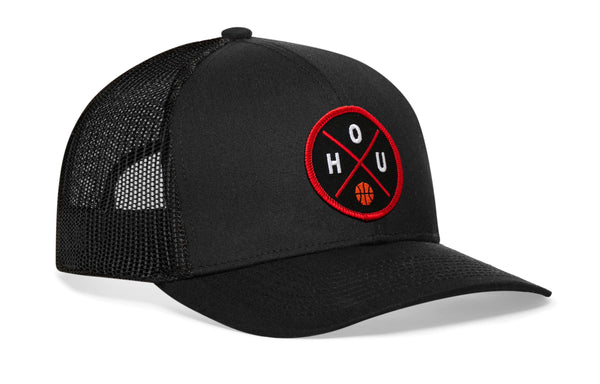 Black trucker snapback cap with front circular logo patch and mesh side panels