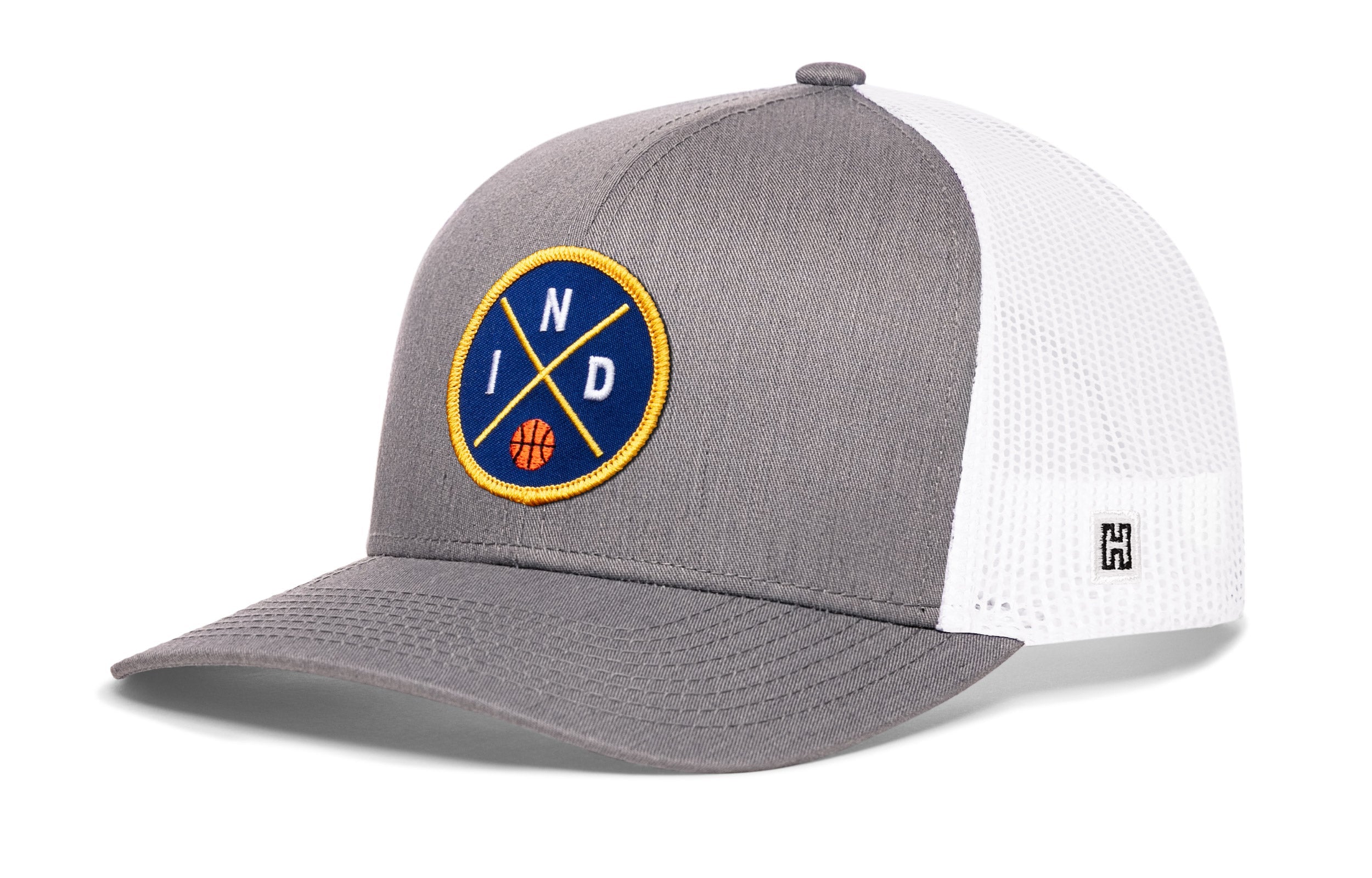 Gray-and-white trucker snapback hat with front circular logo patch and mesh back panel.